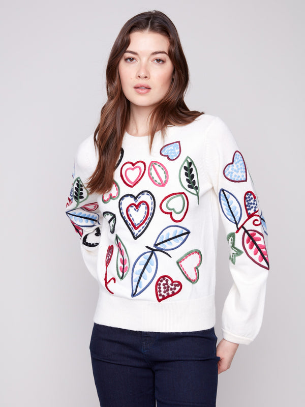 Ecru sweater adorned with hearts and leaves embroidery, showcasing a relaxed fit for ultimate comfort by Charlie B.