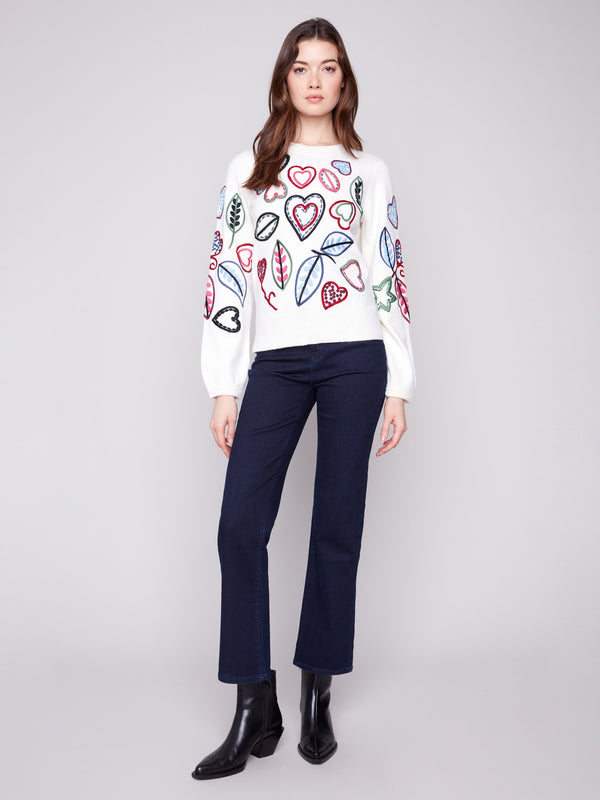 Stylish ecru sweater with vibrant embroidery of hearts and leaves, designed with a classic crew neck by Charlie B.