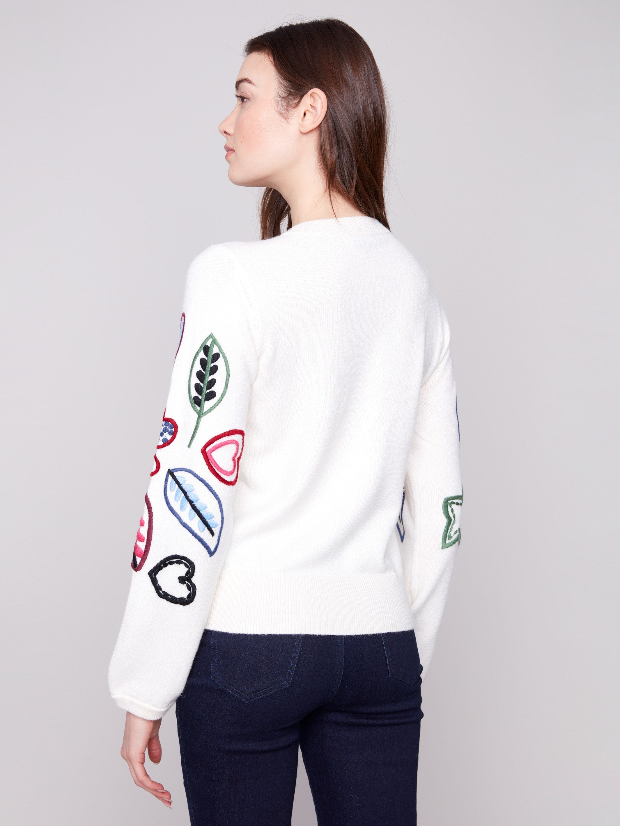 Ecru sweater embellished with colorful hearts and leaves, offering a cozy relaxed fit for any occasion by Charlie B.