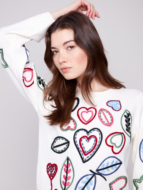 Elegant ecru sweater featuring multicolored heart and leaf embroidery, complete with beautifully crafted puff sleeves by Charlie B.