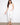 White slim-fit jeans in stretch denim with unique embroidered hem by Charlie B.