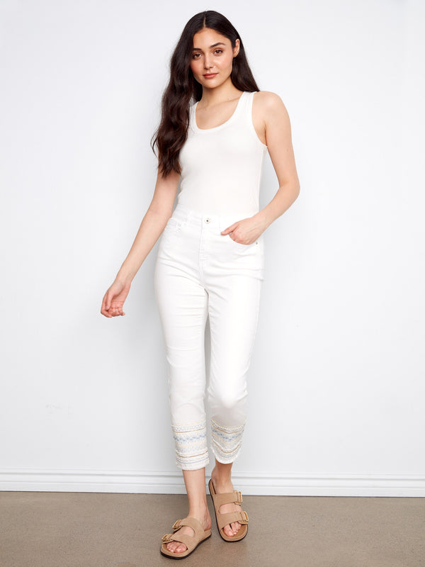 White slim-fit jeans in stretch denim with unique embroidered hem by Charlie B.