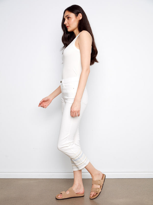 Embroidered hem on white slim-fit jeans adds a chic touch by Charlie B.