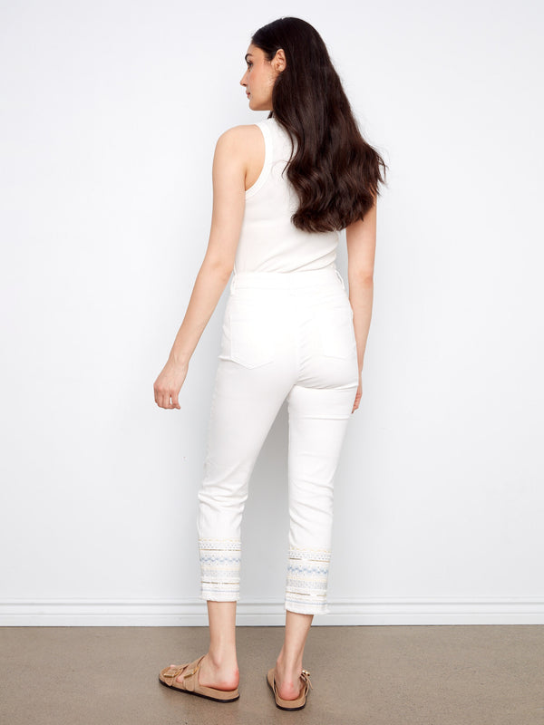 Five-pocket white jeans with intricate embroidery for added flair by Charlie B.