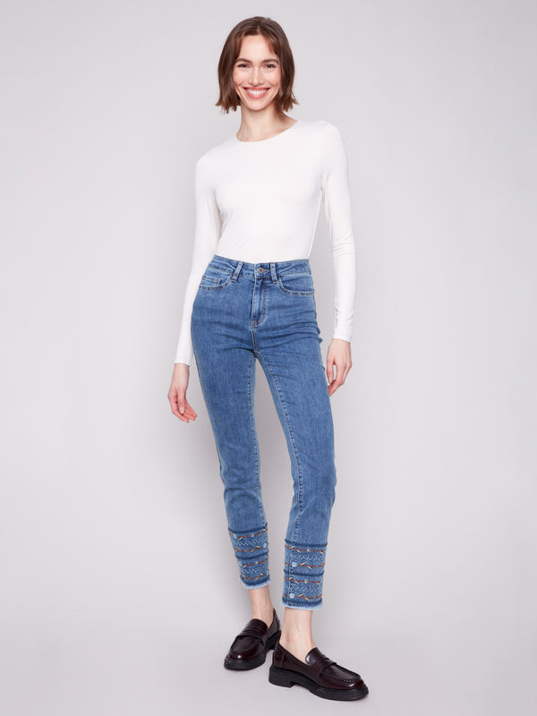 Medium blue jeans with a slim leg fit, featuring ankle-length cut and stylish embroidered hem by Charlie B.