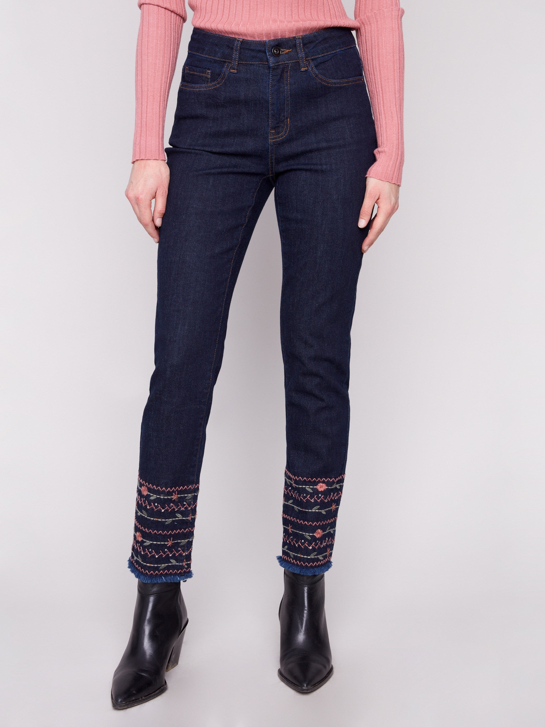 These slim leg jeans feature a five-pocket design, combining practicality with elegance in deep blue denim by Charlie B.