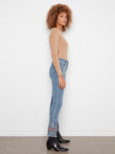 Ankle length slim leg jeans in medium blue, boasting a chic embroidered hem and practical five-pocket design by Charlie B.