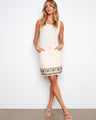 Natural-colored skort featuring a regular rise and intricate embroidered hem detail, styled elegantly by Charlie B.