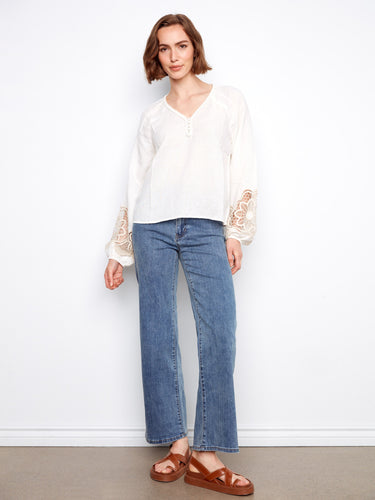 Charming white blouse with openwork lace on the balloon sleeves, adding a touch of elegance to the outfit by Charlie B.