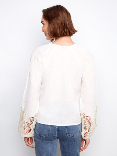 Stylish white blouse showcasing delicate embroidery on balloon sleeves and a comfortable fit for versatile styling by Charlie B.