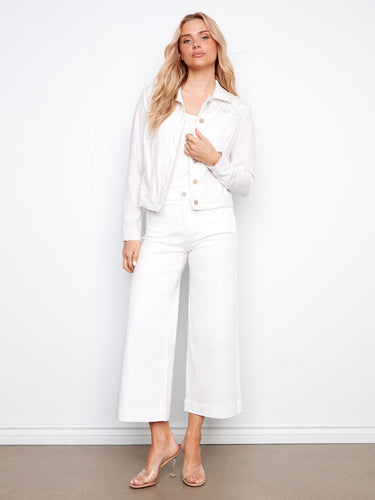 Elegant white linen jacket showcasing frayed edges and front pockets, complete with button details by Charlie B.