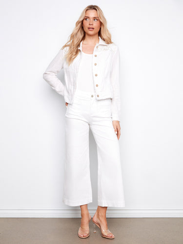 Stylish white linen blend jacket featuring front button closure and practical front pockets for convenience by Charlie B.