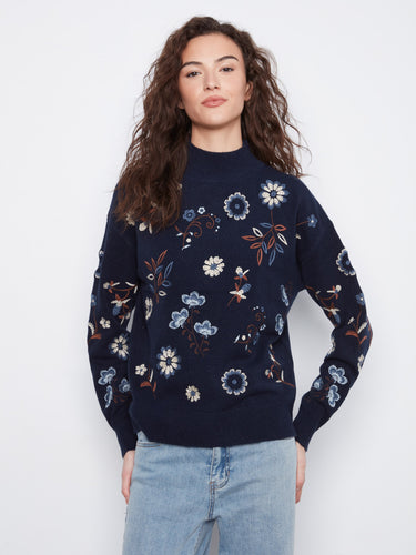 Navy sweater with a mock neck and drop shoulder design, adorned with floral embroidery for a stylish look by Charlie B.