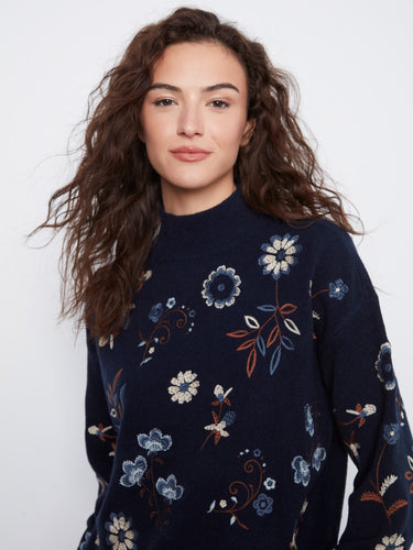 This navy sweater features elegant floral embroidery and long sleeves, perfect for adding charm to your wardrobe by Charlie B.