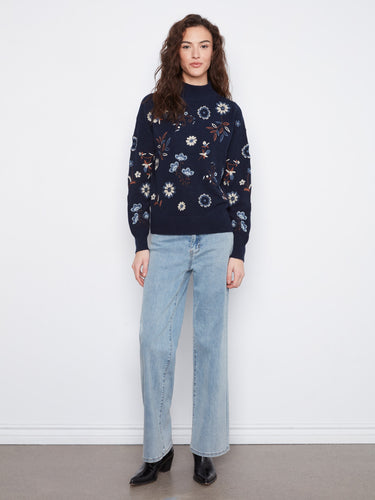 Embrace timeless style with this navy sweater, showcasing intricate floral embroidery and a cozy mock neck by Charlie B.