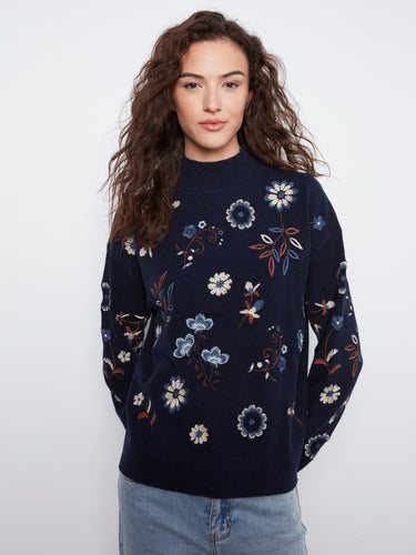 A chic navy sweater boasting a drop shoulder design and beautiful floral details, ideal for any casual outing by Charlie B.