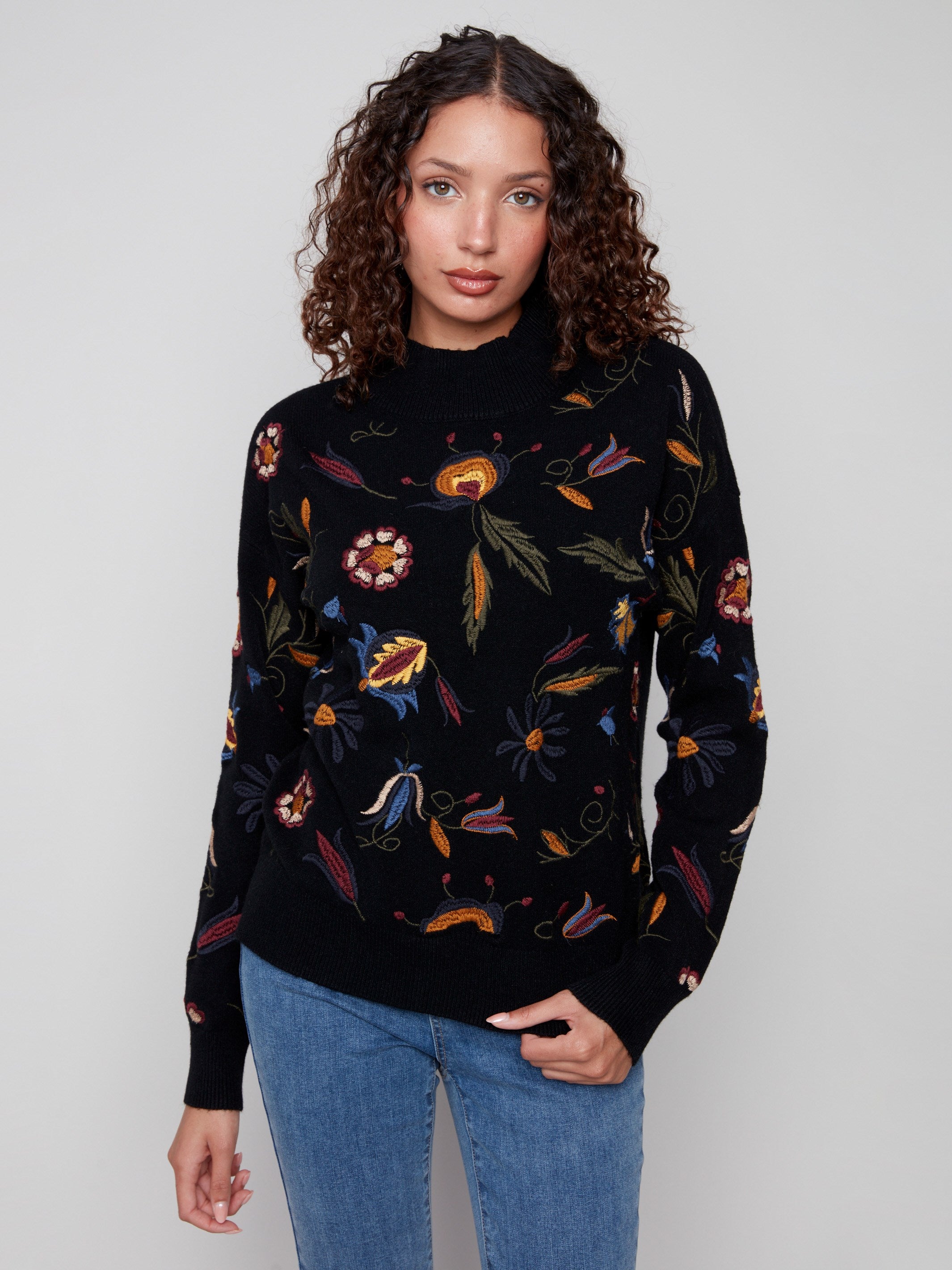Elegant black sweater with intricate embroidered floral details, perfect for a chic look by Charlie B.