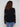 Fashionable black sweater showcasing ribbed cuffs and hem for added texture by Charlie B.