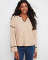 The sweater features a stylish notch neck, adding a modern touch to its classic design. Perfect for any casual occasion. By Charlie B.