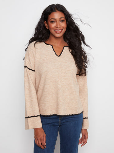 The sweater features a stylish notch neck, adding a modern touch to its classic design. Perfect for any casual occasion. By Charlie B.