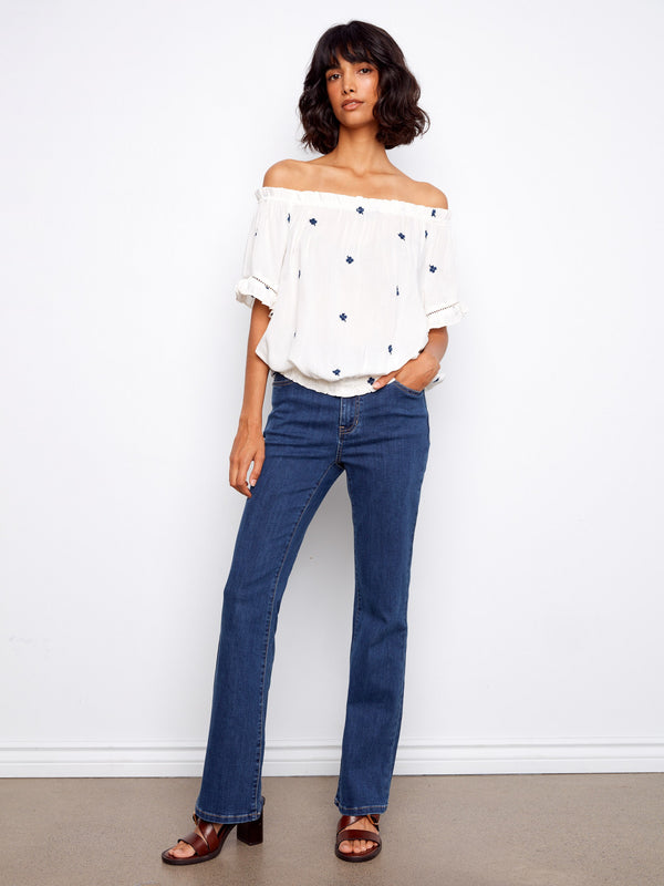 Chic blouse featuring an elastic hem and embroidered flowers for a stylish look by Charlie B.