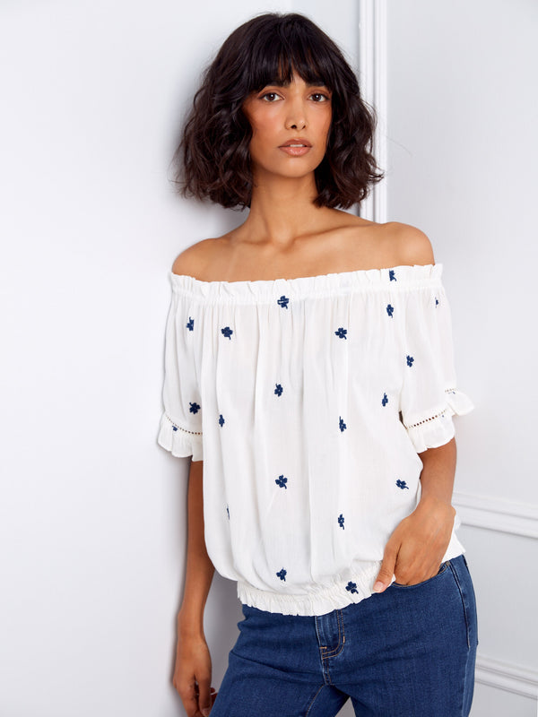 Fashionable off-the-shoulder design with short flutter sleeves and floral accents by Charlie B.