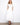 White dress with V-neck and elastic empire waist, featuring hidden pockets for practicality by Charlie B.