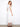White midi dress highlighted by its empire elastic waist and delicate embroidered details by Charlie B.