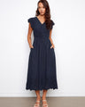 The dress features an empire elastic waist, adding a flattering silhouette for various body types. By Charlie B.