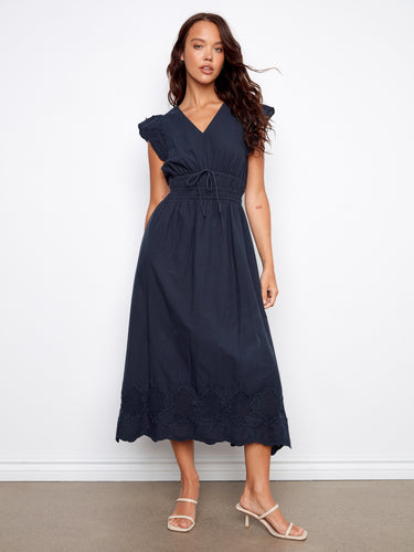 Highlighted by an embroidered border, the dress brings intricate detailing to its classic design. By Charlie B.