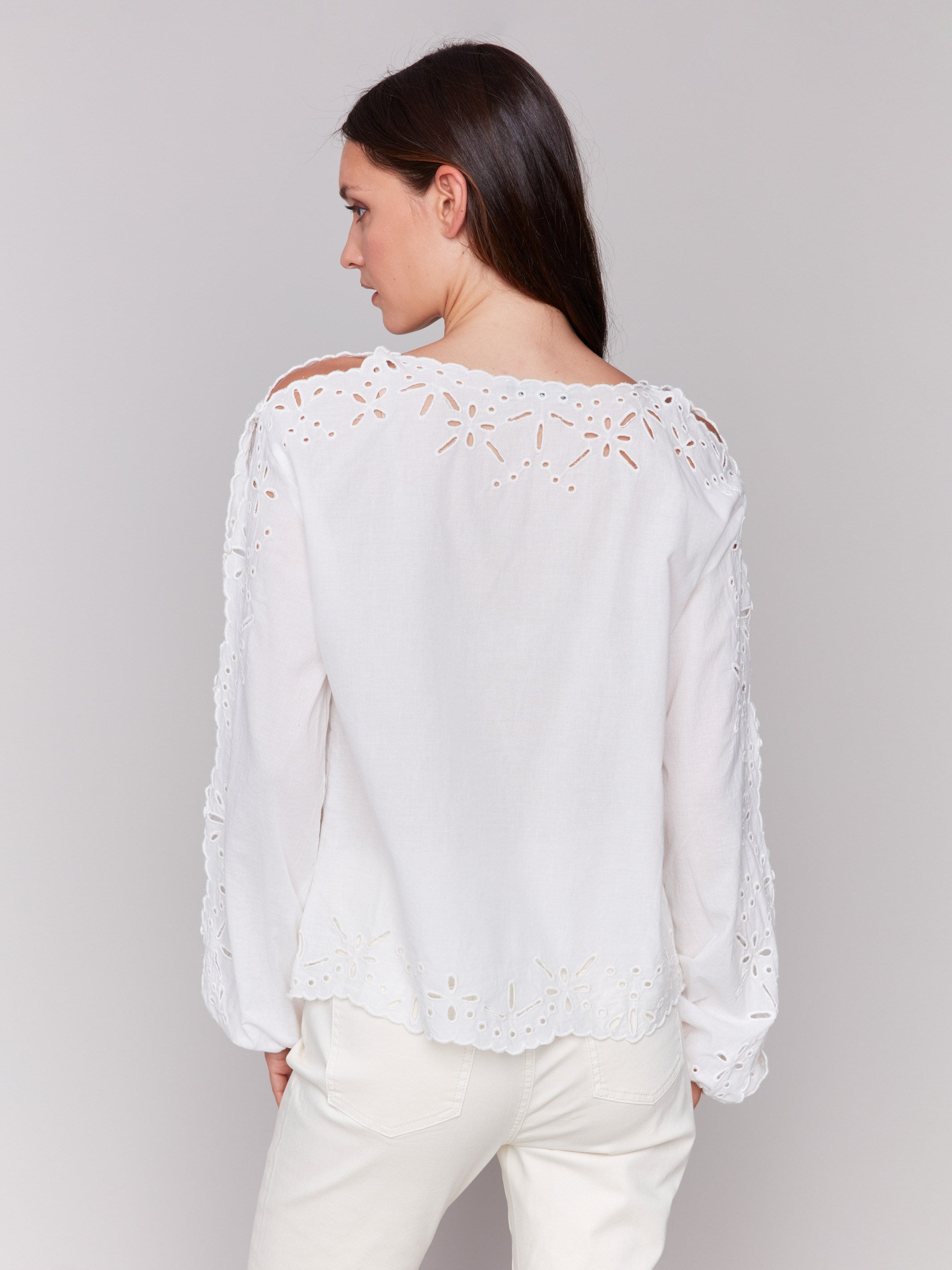 Stylish white top showcasing scalloped edges design by Charlie B.