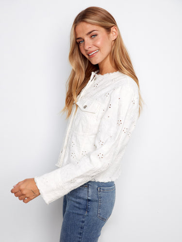 Trendy white eyelet denim jacket highlighting chest flap pockets and secure button closure by Charlie B.