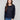 Navy blue chiffon blouse featuring a boat neck and elegant long sleeves, showcasing intricate details by Charlie B.