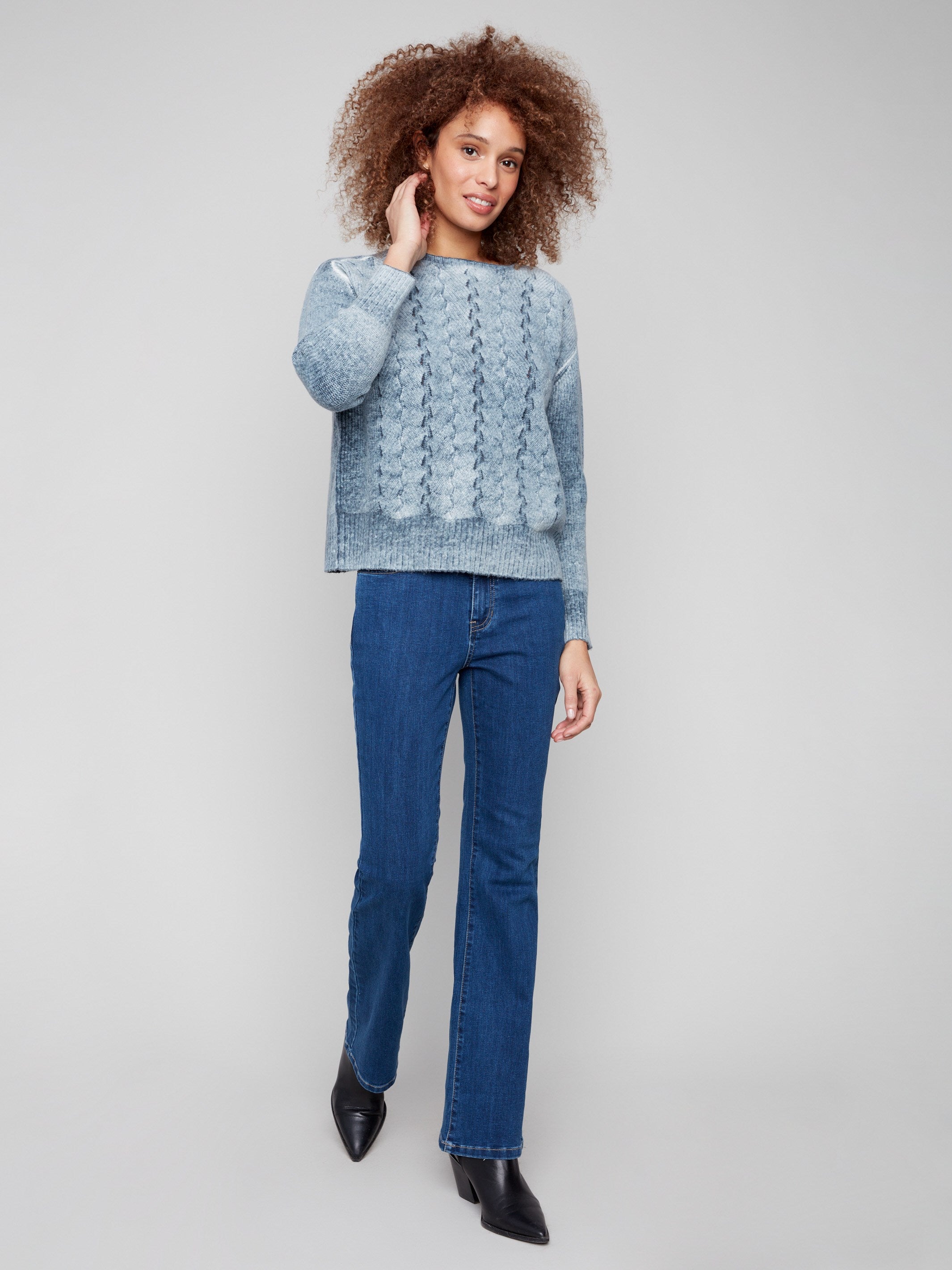 Stylish blue sweater with front cable knit design, ideal for layering in cooler weather by Charlie B.
