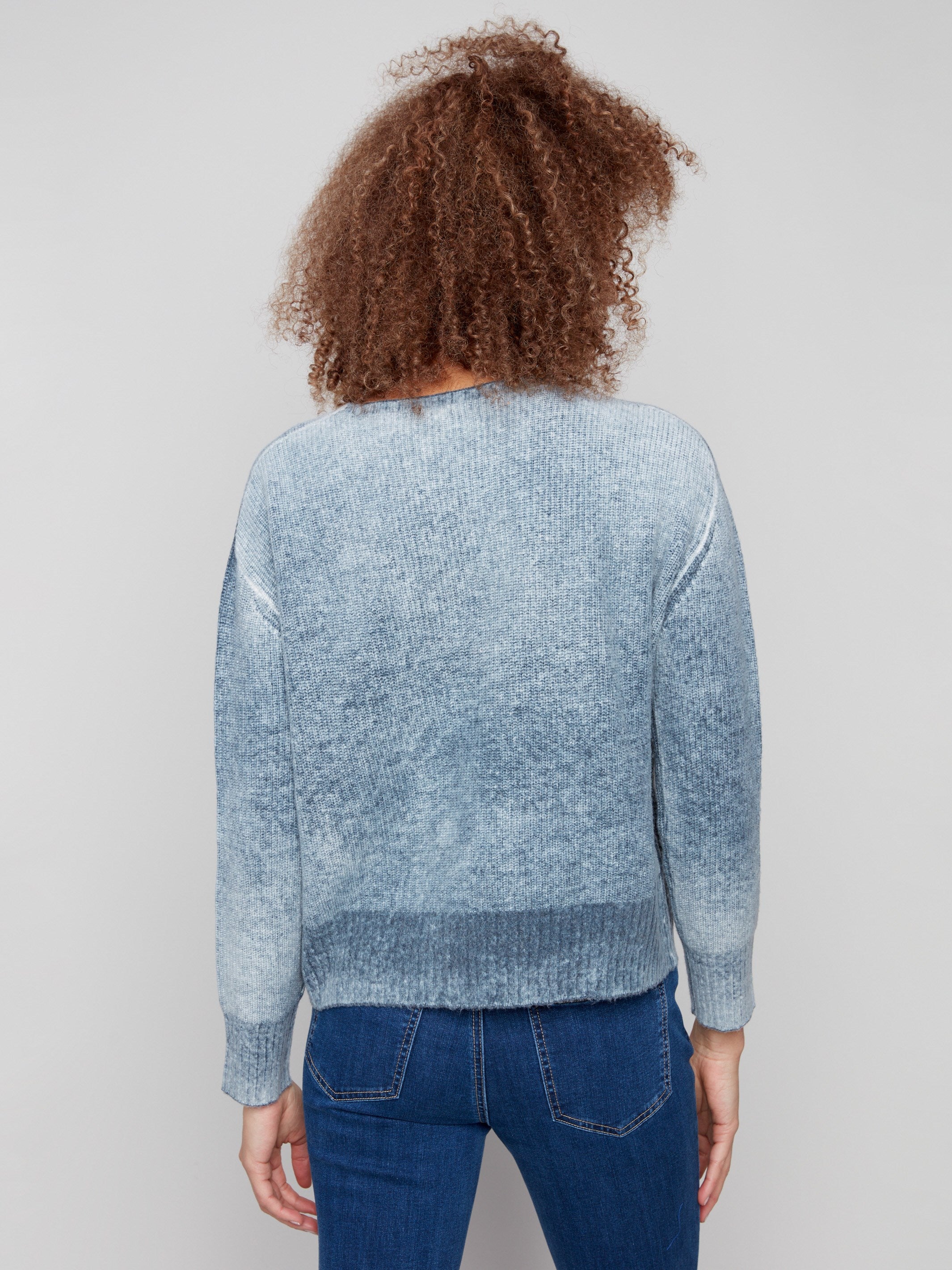 Elegant blue denim sweater showcasing its unique drop shoulder design, adding a relaxed vibe by Charlie B.