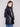 Elegant black faux leather blazer showcasing welt pockets, adding practicality to its chic design by Charlie B.