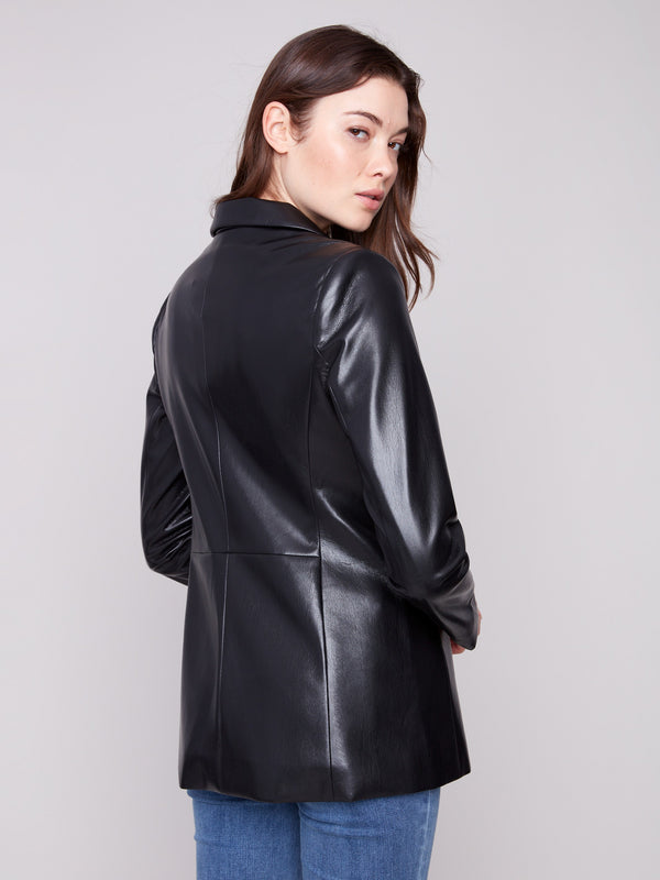 Elegant black faux leather blazer showcasing welt pockets, adding practicality to its chic design by Charlie B.
