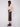 Elegant cabernet faux leather midi skirt in lined fabric, matched with a beige top and brown ankle boots by Charlie B.