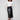 Black faux leather midi skirt featuring side pockets, paired with a white top and black ankle boots by Charlie B.