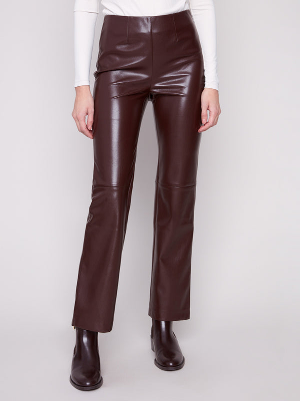 Long length cabernet faux leather pants with sleek detailing and back welt pockets by Charlie B.