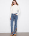 Jeans featuring a flare leg design with intricate embroidery, perfect for adding flair to any outfit. Crafted by Charlie B.