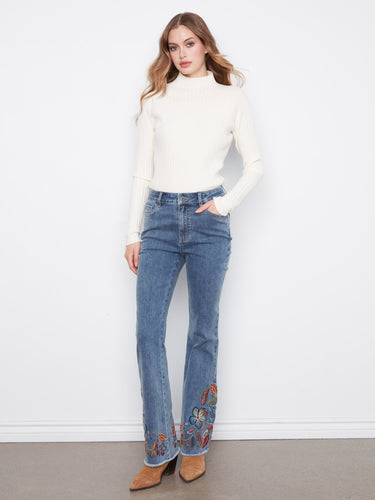 Jeans featuring a flare leg design with intricate embroidery, perfect for adding flair to any outfit. Crafted by Charlie B.