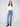 Blue jeans with a long length and vibrant floral embroidery, offering a stylish look by Charlie B.