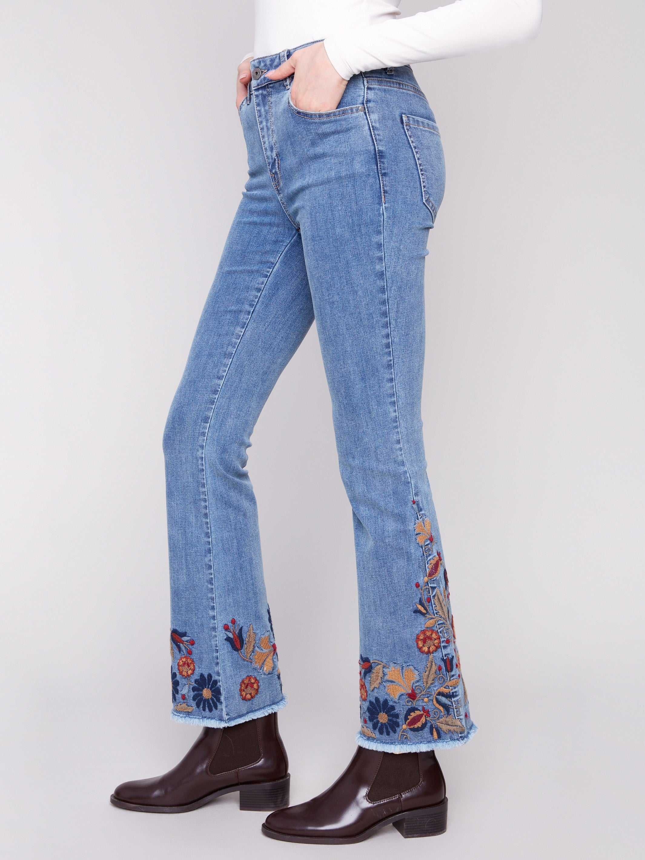 Regular rise blue jeans adorned with intricate floral designs for an elegant touch by Charlie B.