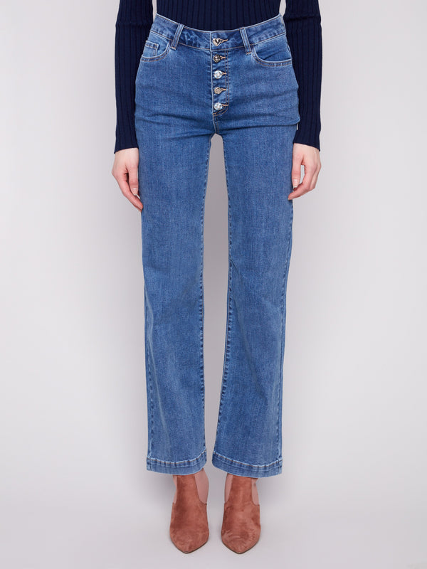 These jeans feature a long length, perfect for elongating the silhouette, paired with a chic top by Charlie B.