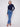 Embellished buttons add flair to these medium blue jeans, perfectly matched with a sleek dark top by Charlie B.