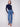 Stretch denim in medium blue provides comfort and style when paired with this sophisticated dark top by Charlie B.