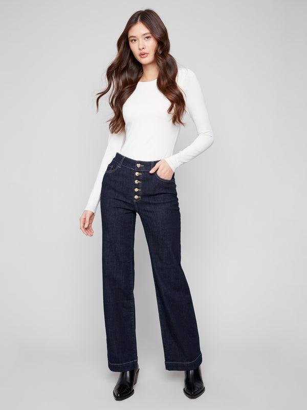 Deep blue jeans in a flare fit with stylish front buttons, offering a chic look by Charlie B.