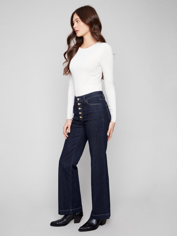 Chic deep blue jeans with a trendy embellished button closure for added flair by Charlie B.