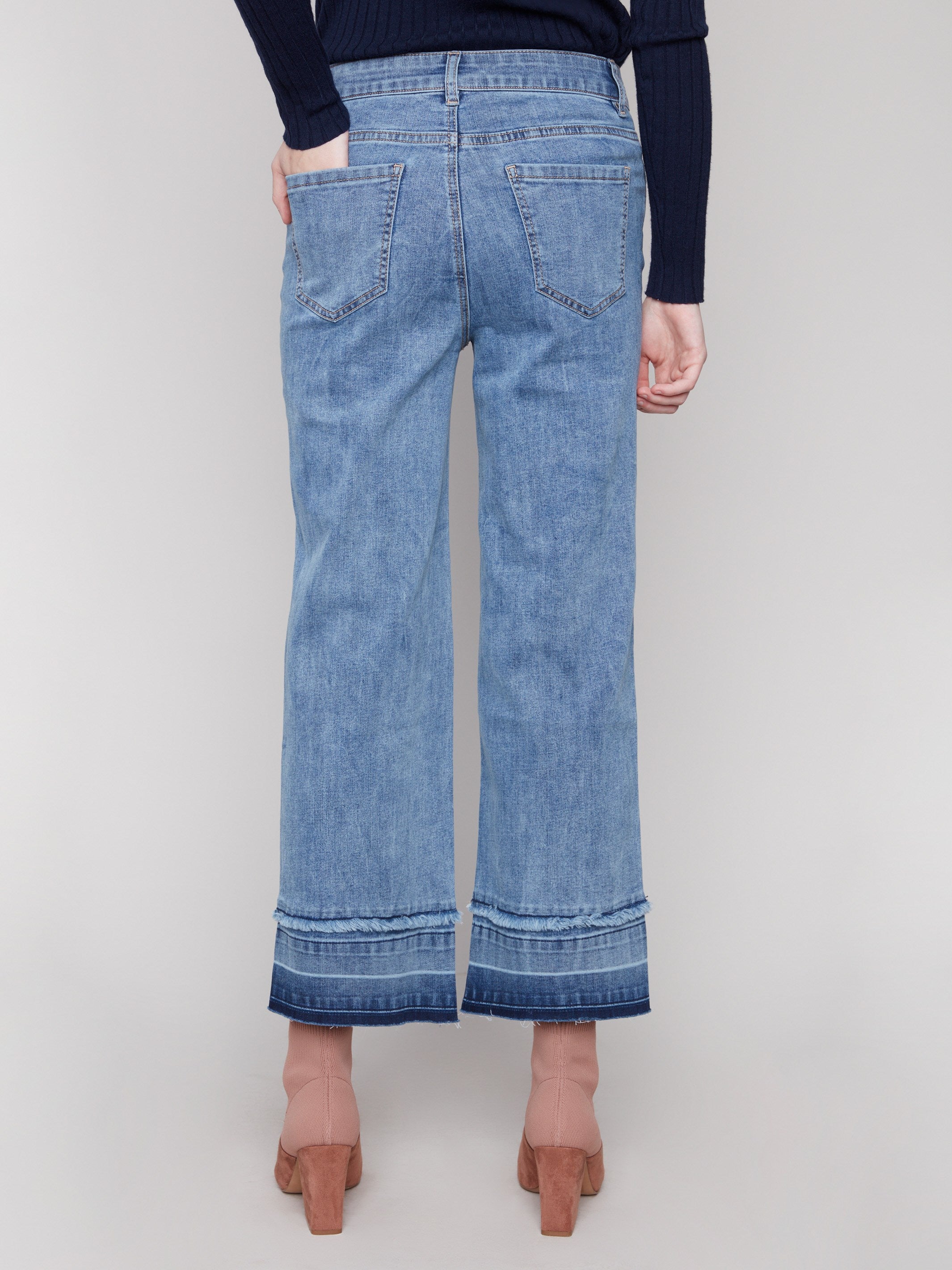 Five-pocket style medium blue jeans designed with regular rise for everyday wear by Charlie B.